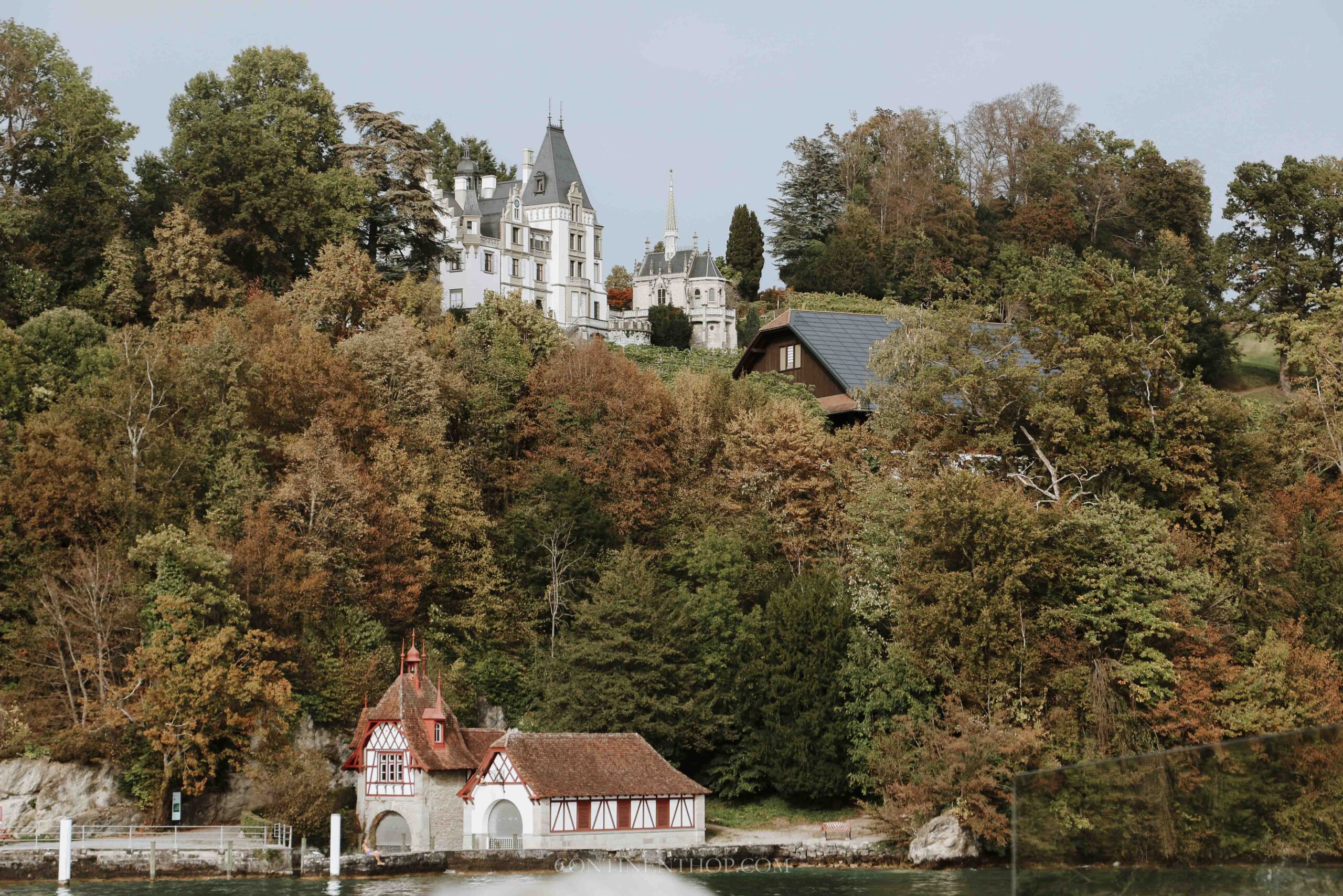 A pretty chapel on a hill by the river in autumn in Switzerland in fall